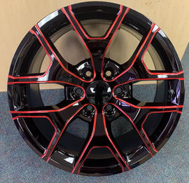 Bold black alloy wheel with striking red accents and multi-spoke design, perfect for car customization from Tires On Wheel.