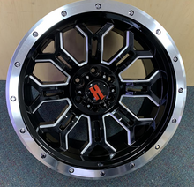 Load image into Gallery viewer, Tough black alloy wheel with silver accents and bold red center cap, perfect for off-road customization from Tires On Wheel.